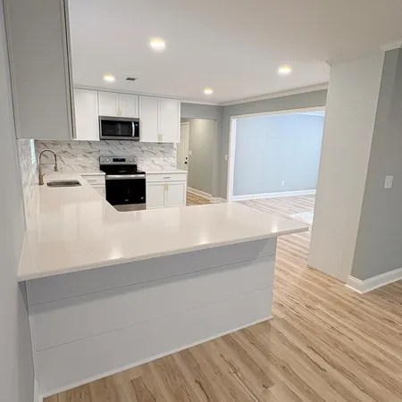 a kitchen with stainless steel appliances a refrigerator sink and microwave