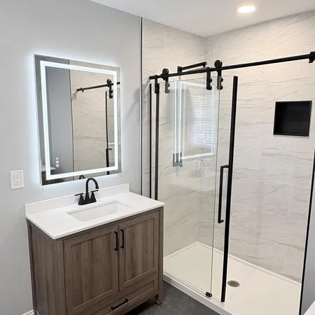 a bathroom with a shower sink and mirror