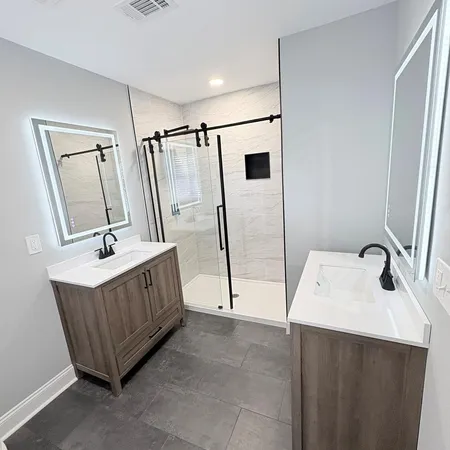 a bathroom with a sink a tub and a mirror