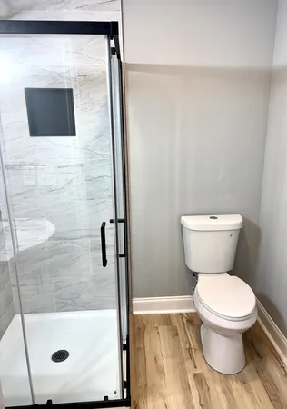 a bathroom with a toilet and a shower