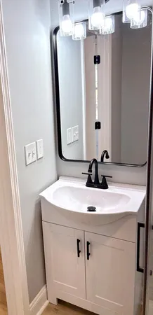 a bathroom with a sink vanity and mirror