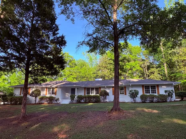 a house that has a tree in front of it