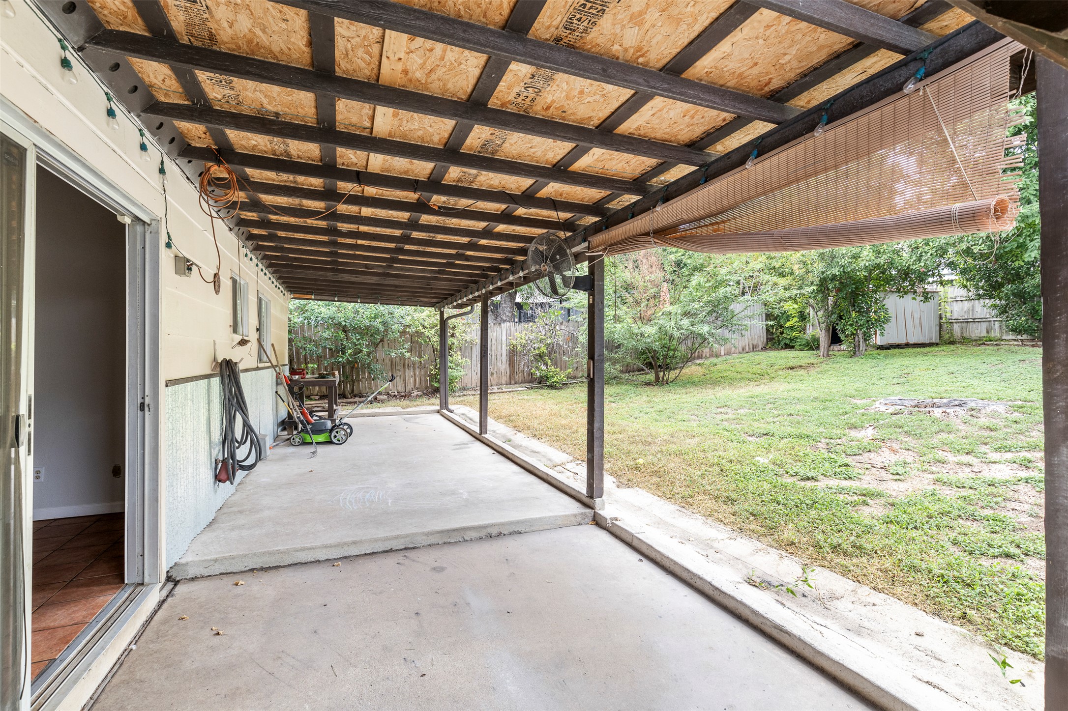 7506 Glenhill Road Austin, TX 78752 - Photo 18 of 24 A covered patio provides an outdoor living extension to this home's generous yard.