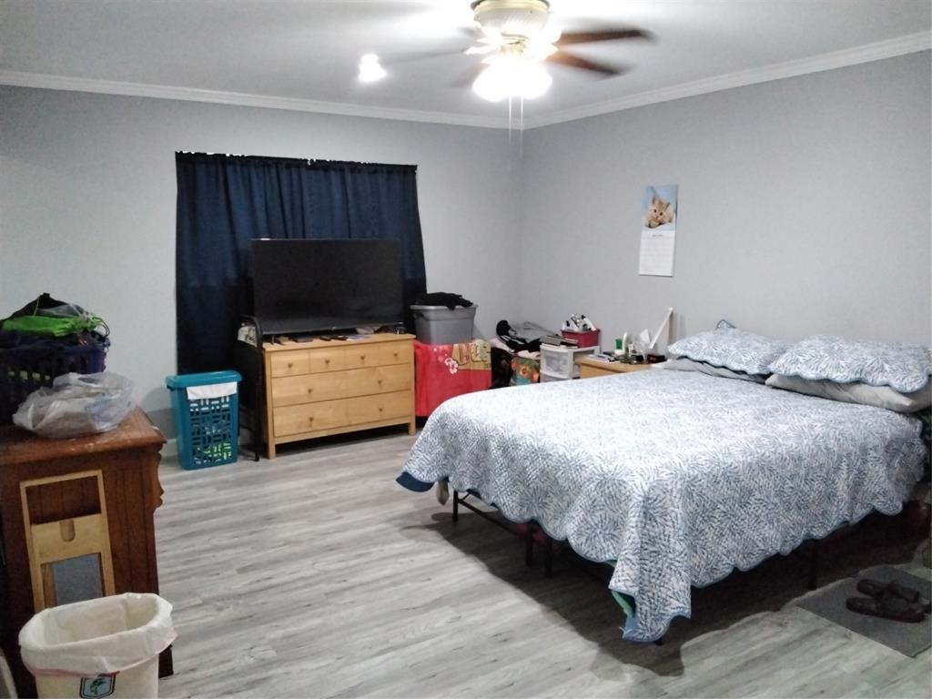 5036 Arbor Glen Road The Colony, TX 75056 - Photo 11 of 29 a spacious bedroom with a bed and a flat screen television