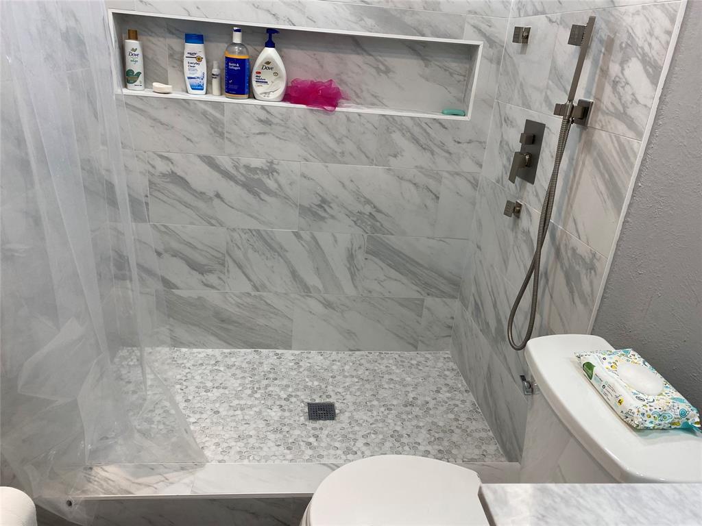 5036 Arbor Glen Road The Colony, TX 75056 - Photo 12 of 29 a bathroom with a toilet and a shower