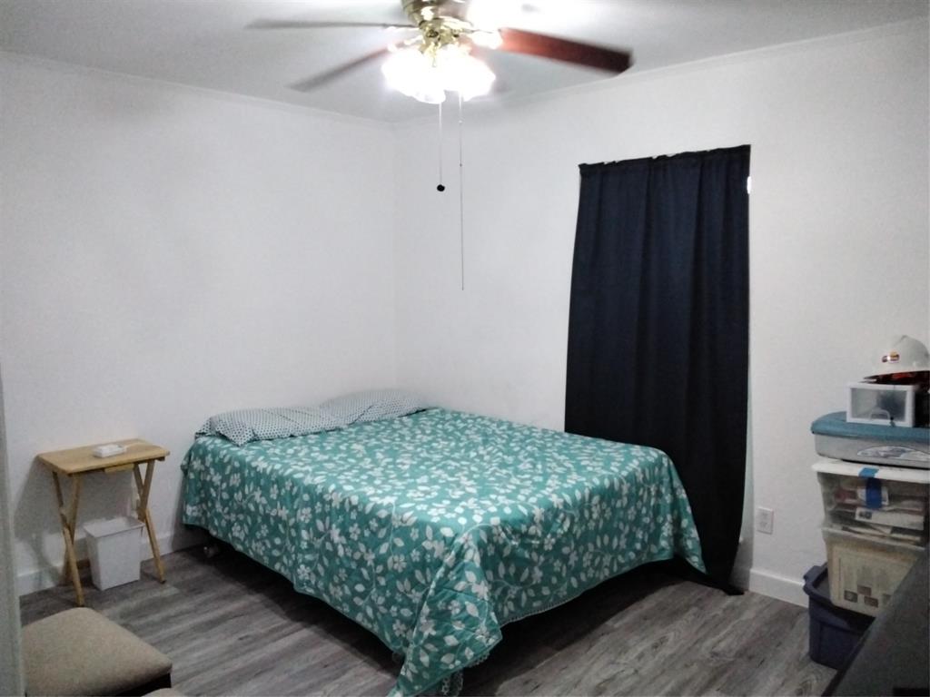 5036 Arbor Glen Road The Colony, TX 75056 - Photo 16 of 29 a bedroom with a bed and a chandelier
