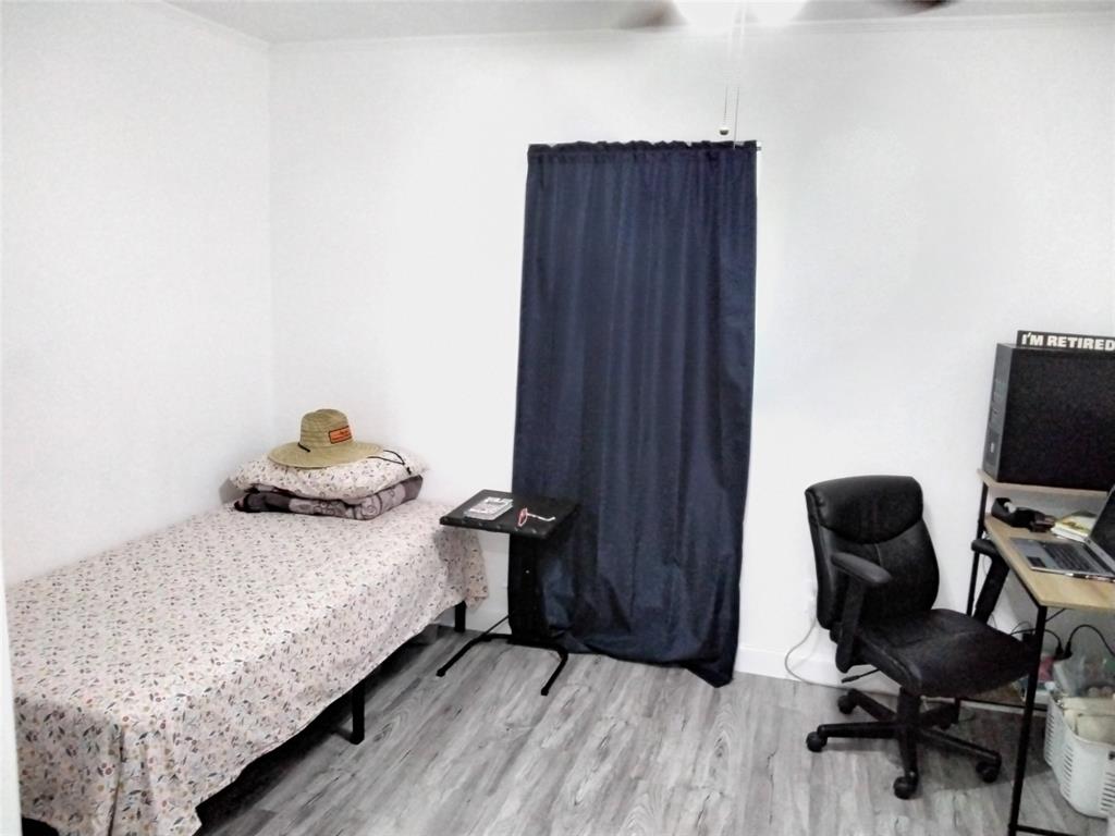 5036 Arbor Glen Road The Colony, TX 75056 - Photo 20 of 29 a bedroom with a bed and a chair