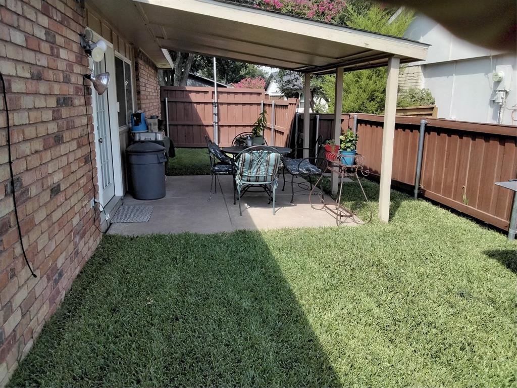 5036 Arbor Glen Road The Colony, TX 75056 - Photo 23 of 29 a view of a patio with table and chairs under an umbrella