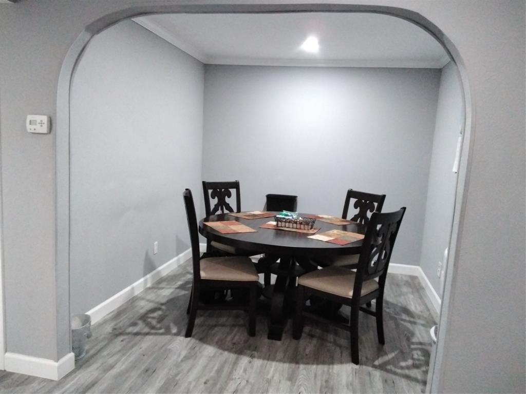 5036 Arbor Glen Road The Colony, TX 75056 - Photo 6 of 29 a view of a dining room with furniture and wooden floor