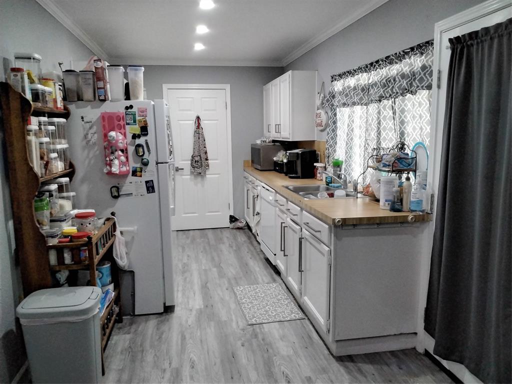 5036 Arbor Glen Road The Colony, TX 75056 - Photo 9 of 29 a kitchen with a refrigerator and a stove top oven