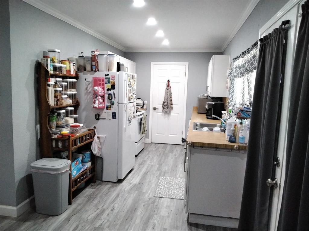5036 Arbor Glen Road The Colony, TX 75056 - Photo 10 of 29 a kitchen with a refrigerator and a stove