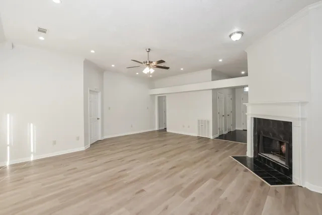 an empty room with fan and entrance