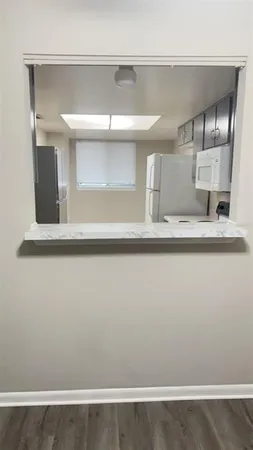 a view of kitchen cabinets and wooden floor