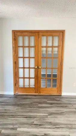 a view of a room with wooden floor and windows