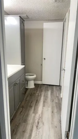 a bathroom with a toilet sink and a mirror