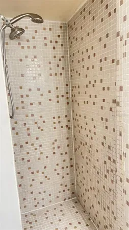 a bathroom with a shower and a sink