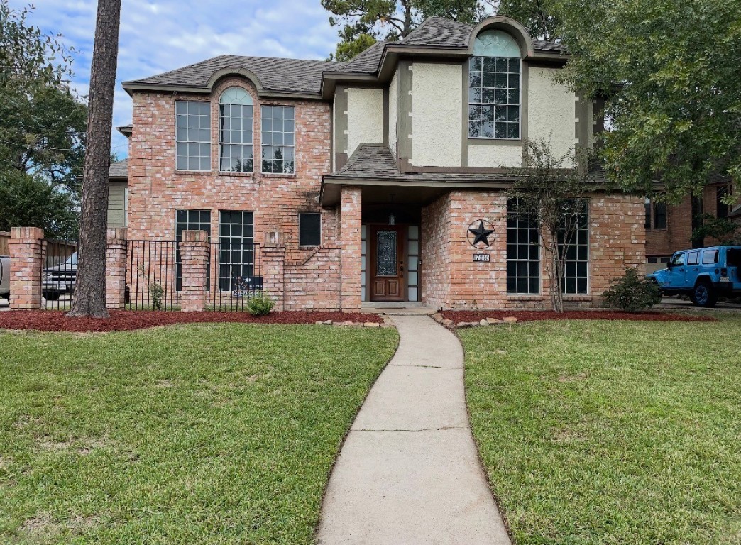 a front view of a house with a garden