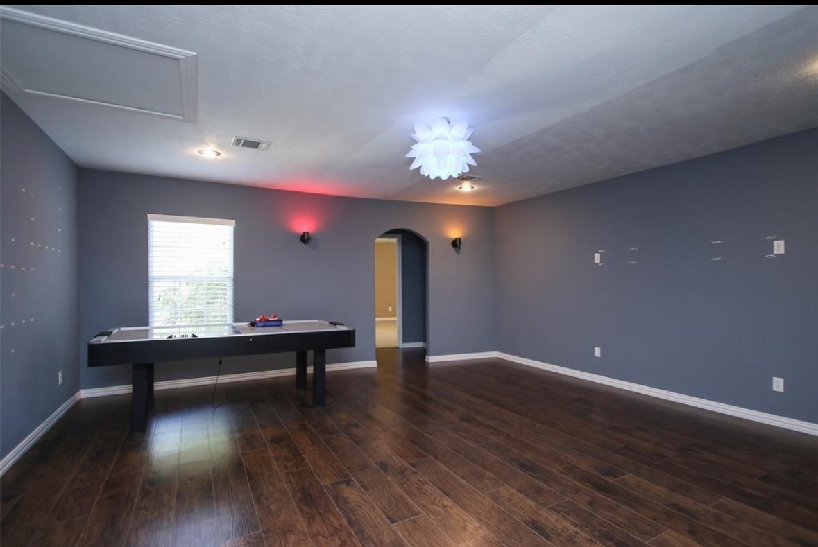 17810 Clearlight Lane Spring, TX 77379 - Photo 12 of 14 a view of room with a ceiling fan and wooden floor