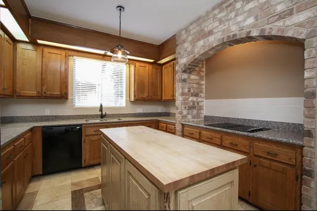 a kitchen that has a sink a stove and a microwave