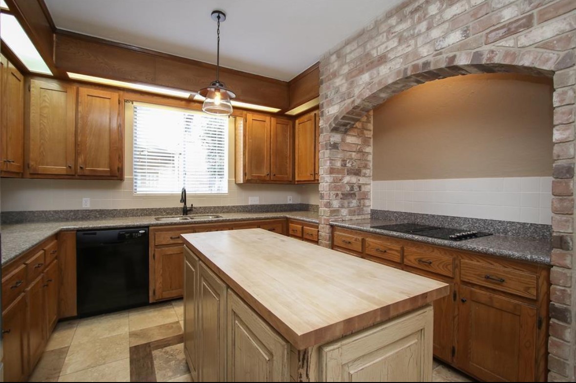 17810 Clearlight Lane Spring, TX 77379 - Photo 7 of 14 a kitchen that has a sink a stove and a microwave