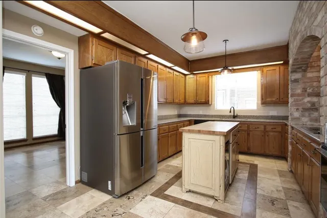a kitchen with a refrigerator a sink and a stove