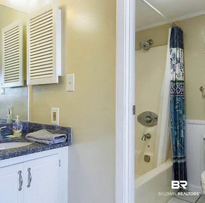 375 Plantation Road, Unit 5602 Gulf Shores, AL 36542 - Photo 7 of 11 Bathroom vanity with a dark speckled countertop, undermount sink, and white cabinetry