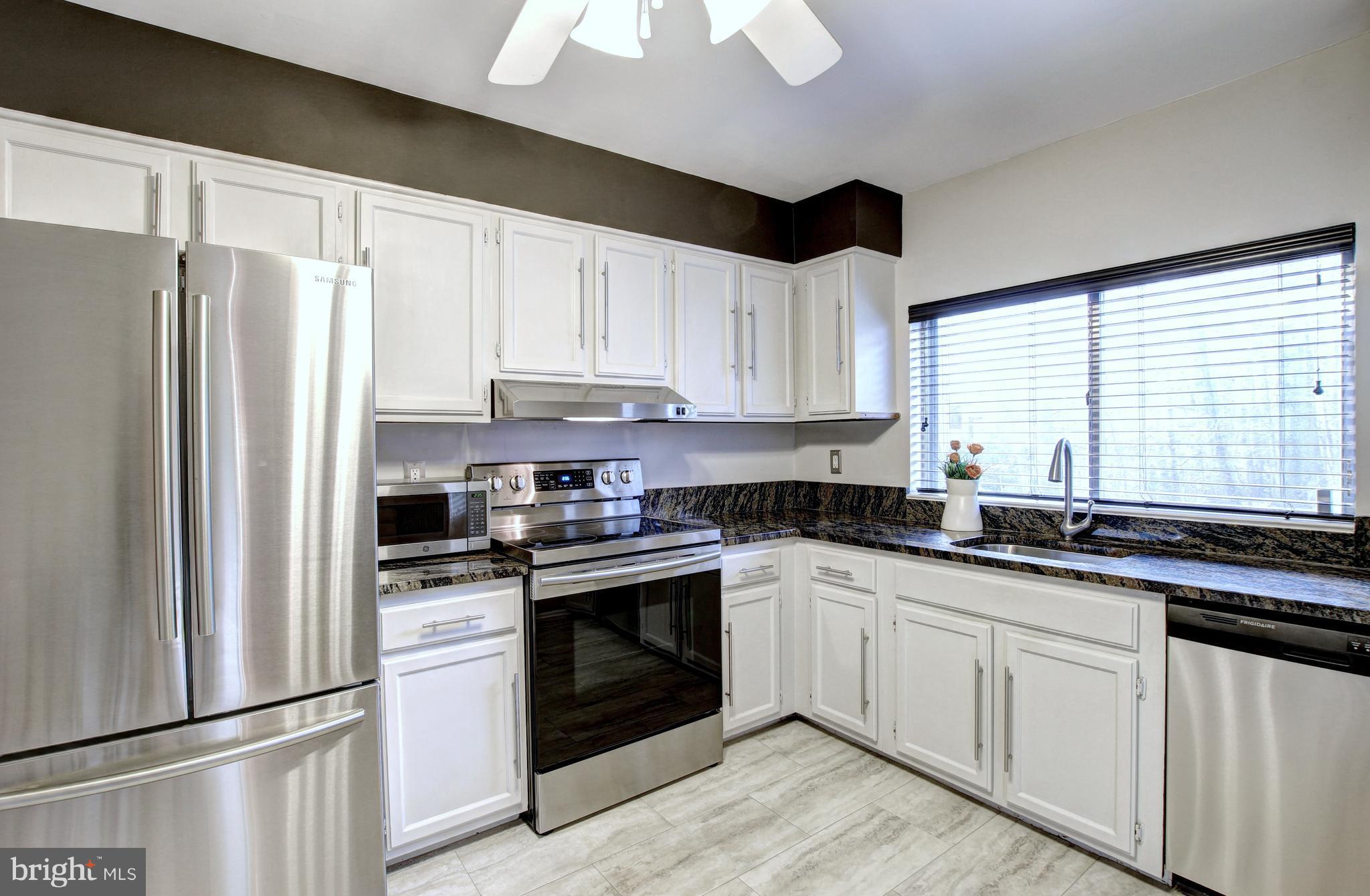 1535 Inlet Court Reston, VA 20190 - Photo 3 of 30 a kitchen with granite countertop white cabinets white stainless steel appliances and a refrigerator