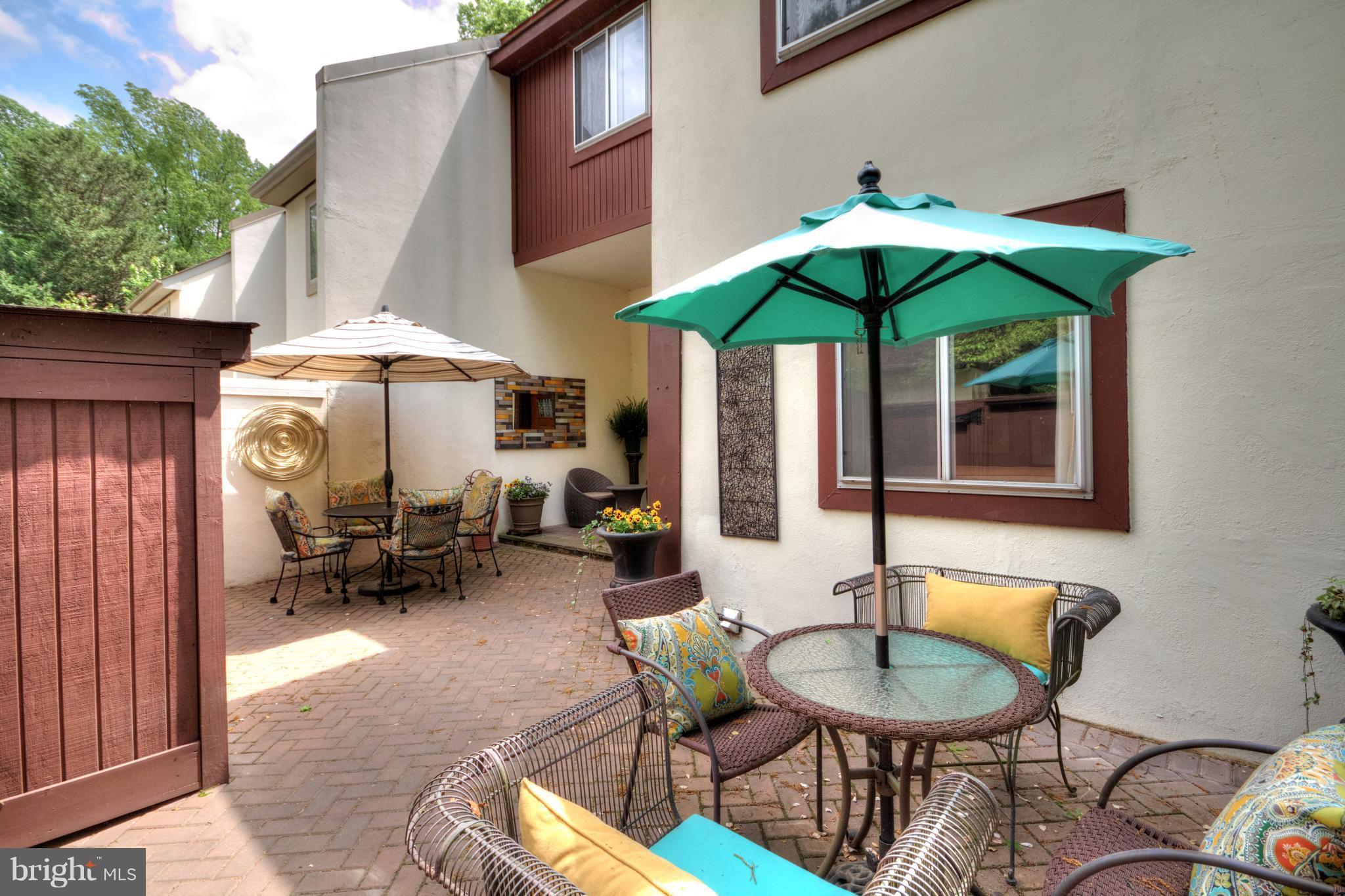 1535 Inlet Court Reston, VA 20190 - Photo 22 of 30 a patio with a table and chairs under an umbrella