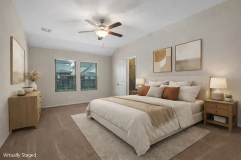 a bedroom with a large bed and a chandelier