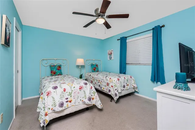 a bedroom with two beds and a chandelier