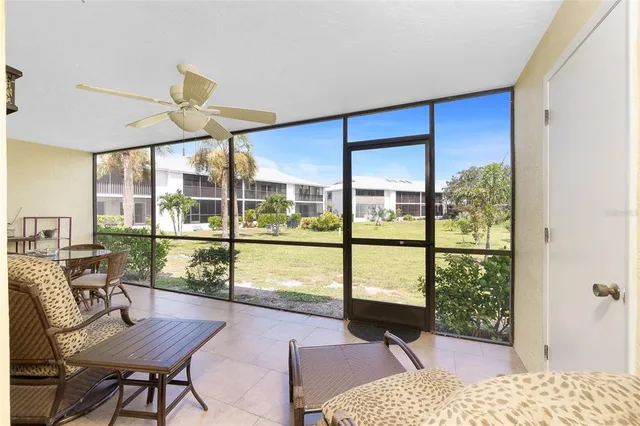 a view of a living room and floor to ceiling window or wooden floor