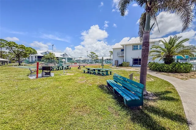 a swimming pool with outdoor seating and yard