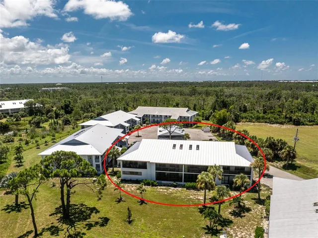 a view of a big yard with lawn chairs
