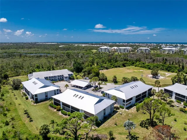 a view of a patio with lawn chairs under an umbrella