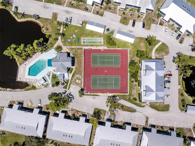 an aerial view of multiple houses with a yard