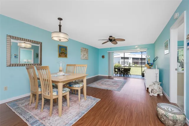 a view of a dining room with furniture wooden floor and chandelier