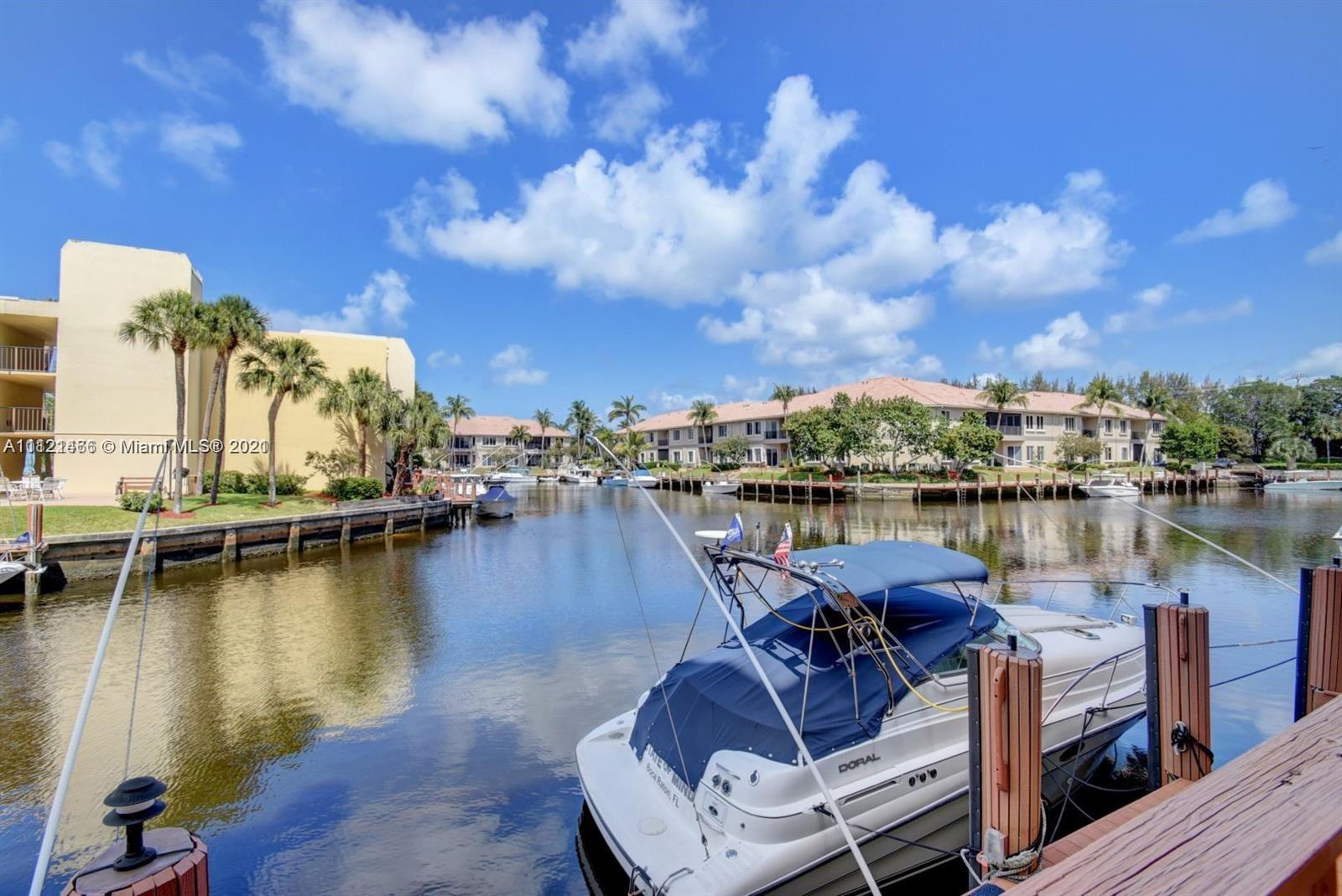 9 Royal Palm Way, Unit 6030 Boca Raton, FL 33432 - Photo 14 of 17 a view of a lake with lawn chairs