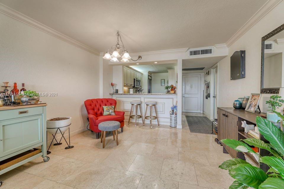 9 Royal Palm Way, Unit 6030 Boca Raton, FL 33432 - Photo 6 of 17 a living room with furniture and a chandelier