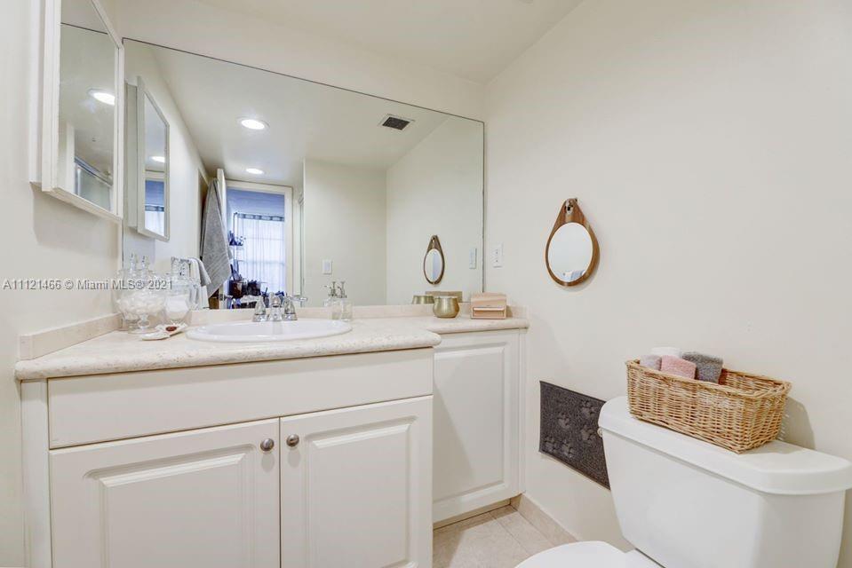 9 Royal Palm Way, Unit 6030 Boca Raton, FL 33432 - Photo 9 of 17 a bathroom with a toilet sink and mirror