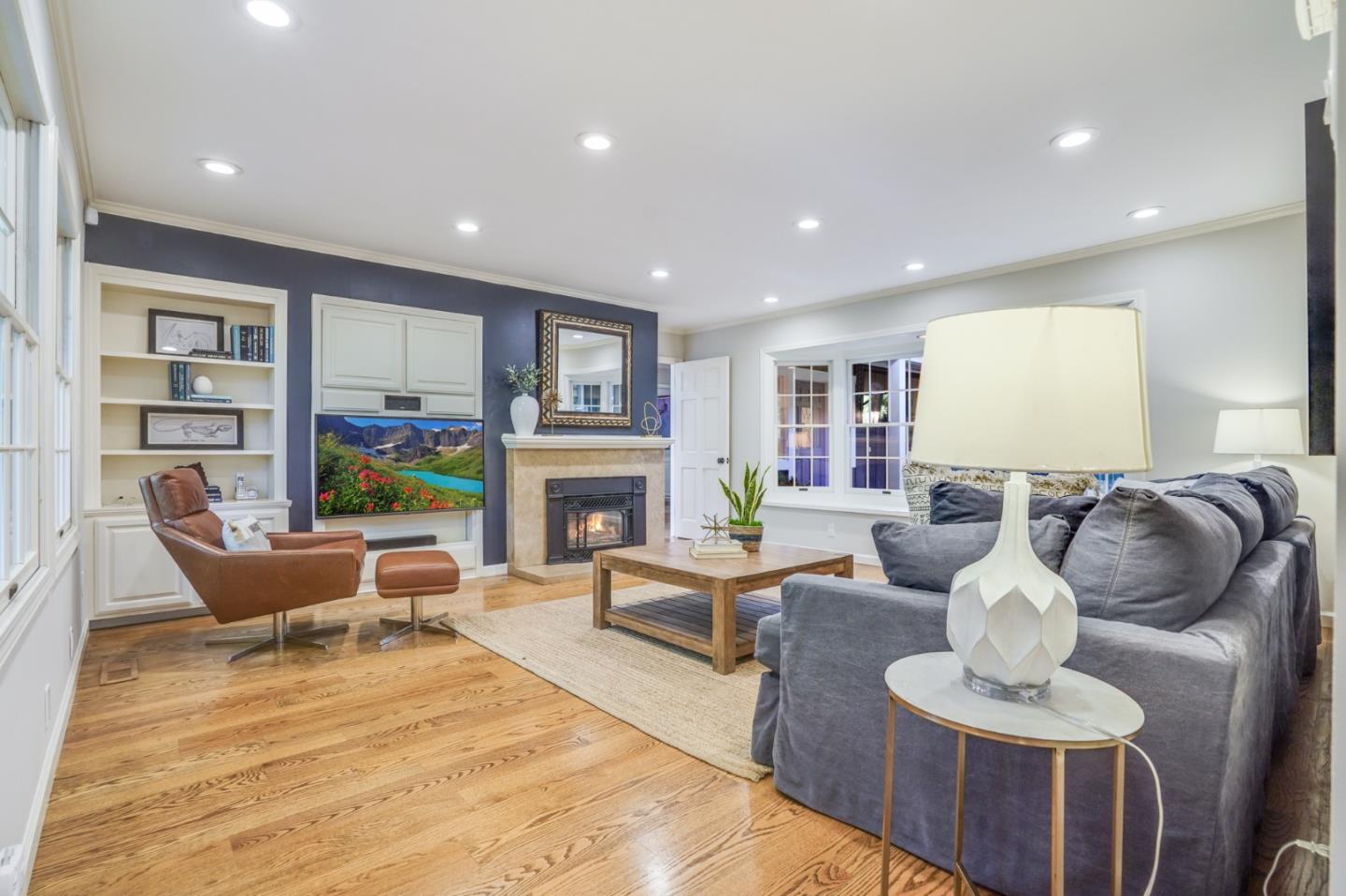 445 Walsh Road Atherton, CA 94027 - Photo 11 of 37 a living room with fireplace furniture and a wooden floor