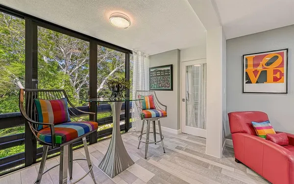 a living room with furniture and floor to ceiling windows
