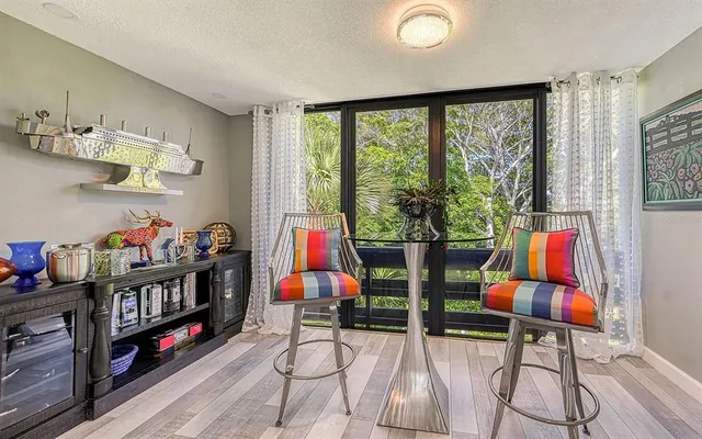 a living room with furniture and a floor to ceiling window