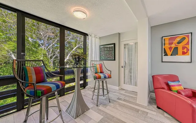 a living room with furniture and floor to ceiling windows