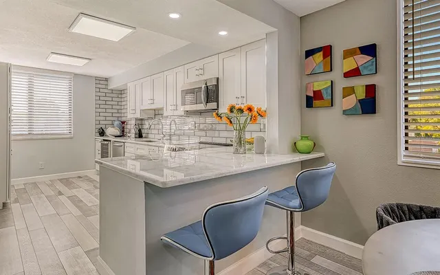 a kitchen with granite countertop cabinets and window