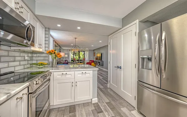 a kitchen with stainless steel appliances a refrigerator sink and cabinets