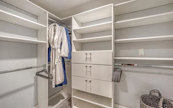 a view of walk in closet with empty racks