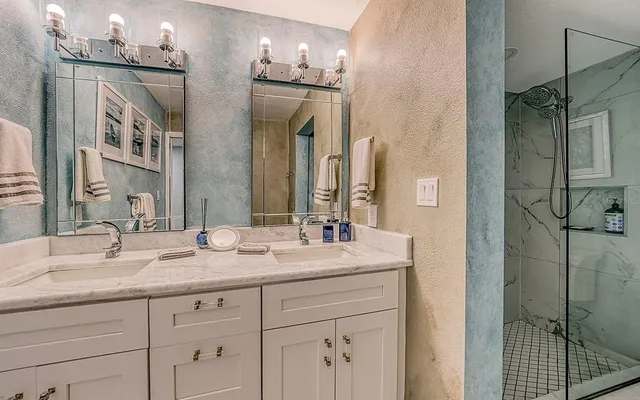 a bathroom with a double vanity sink mirror and double