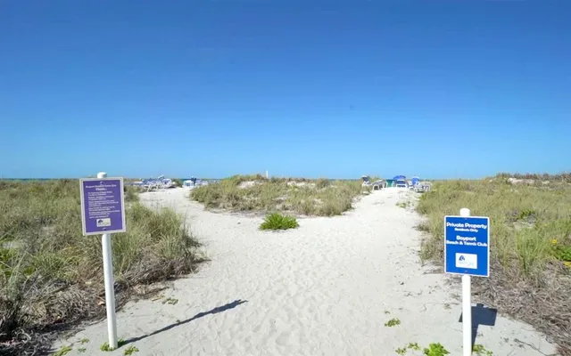 a street sign on a pole next to a road
