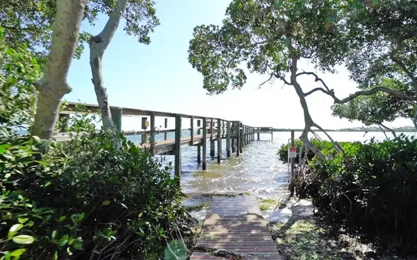 a view of balcony with wooden floor and fence