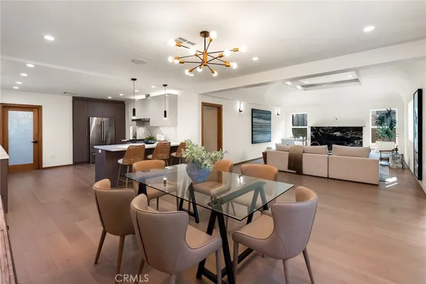 a living room with furniture and kitchen view